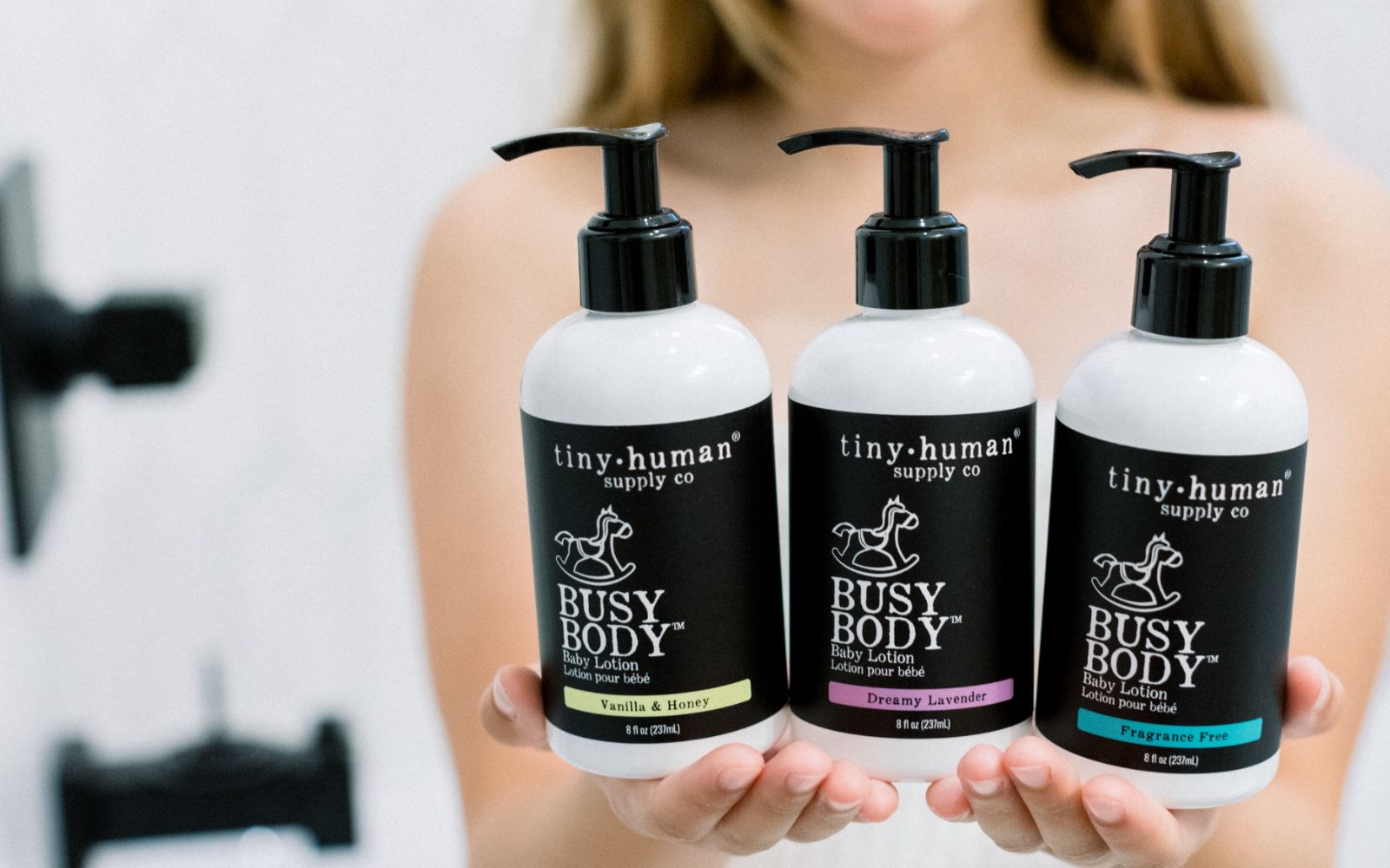 child holding tiny human supply co baby lotion organic skincare