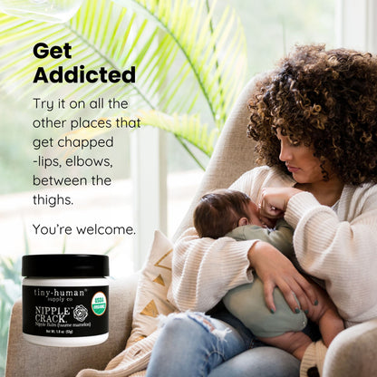 Woman holding a baby with a bottle of nipple crack cream in a cozy setting.