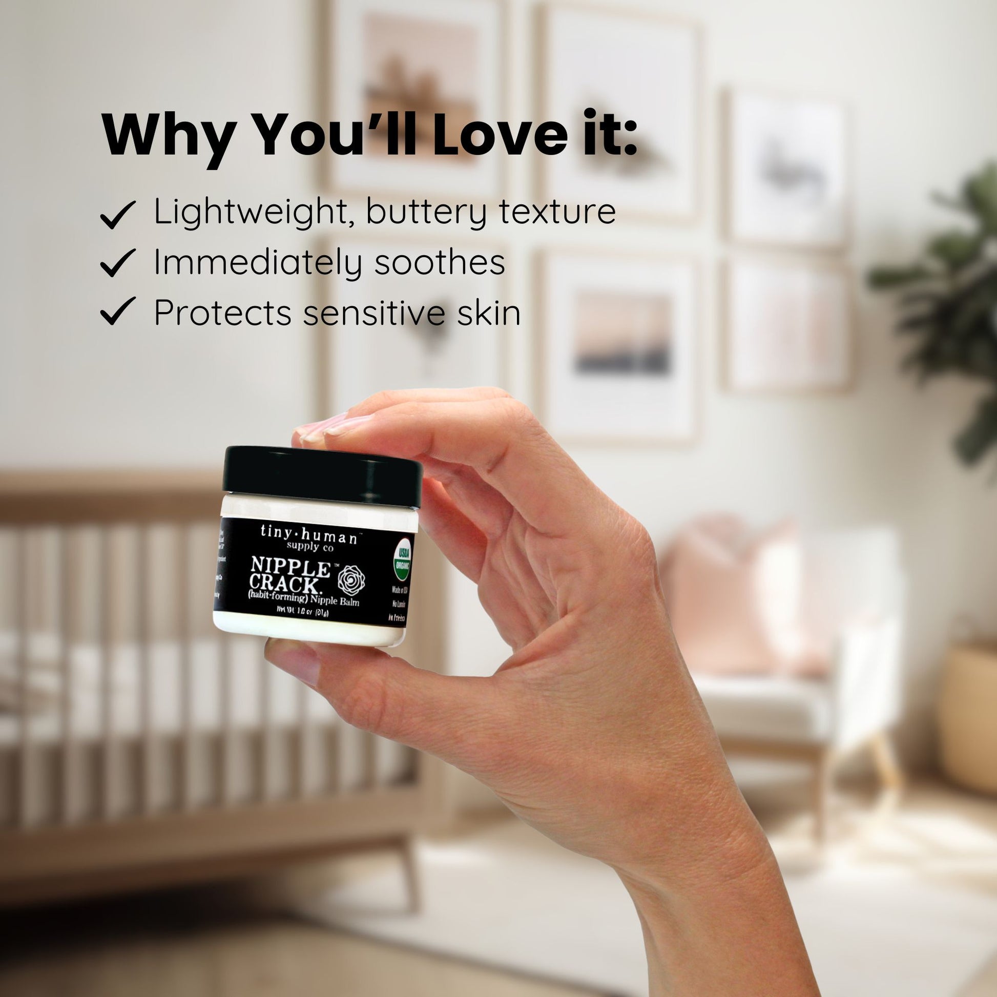 Hand holding a jar of 'Nipple Crack' cream with a blurred indoor background