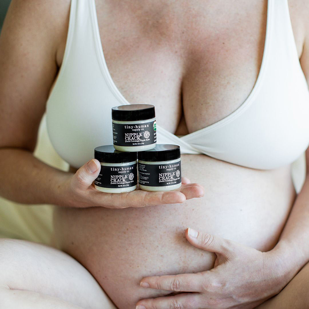 Pregnant woman holding tiny human supply Nipple Crack Organic Nipple Cream