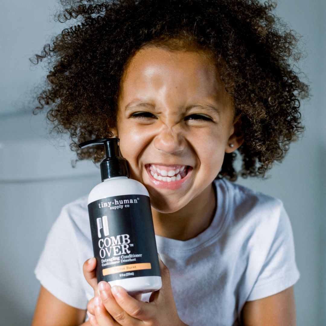 toddler holding tiny human supply organic skincare and haircare