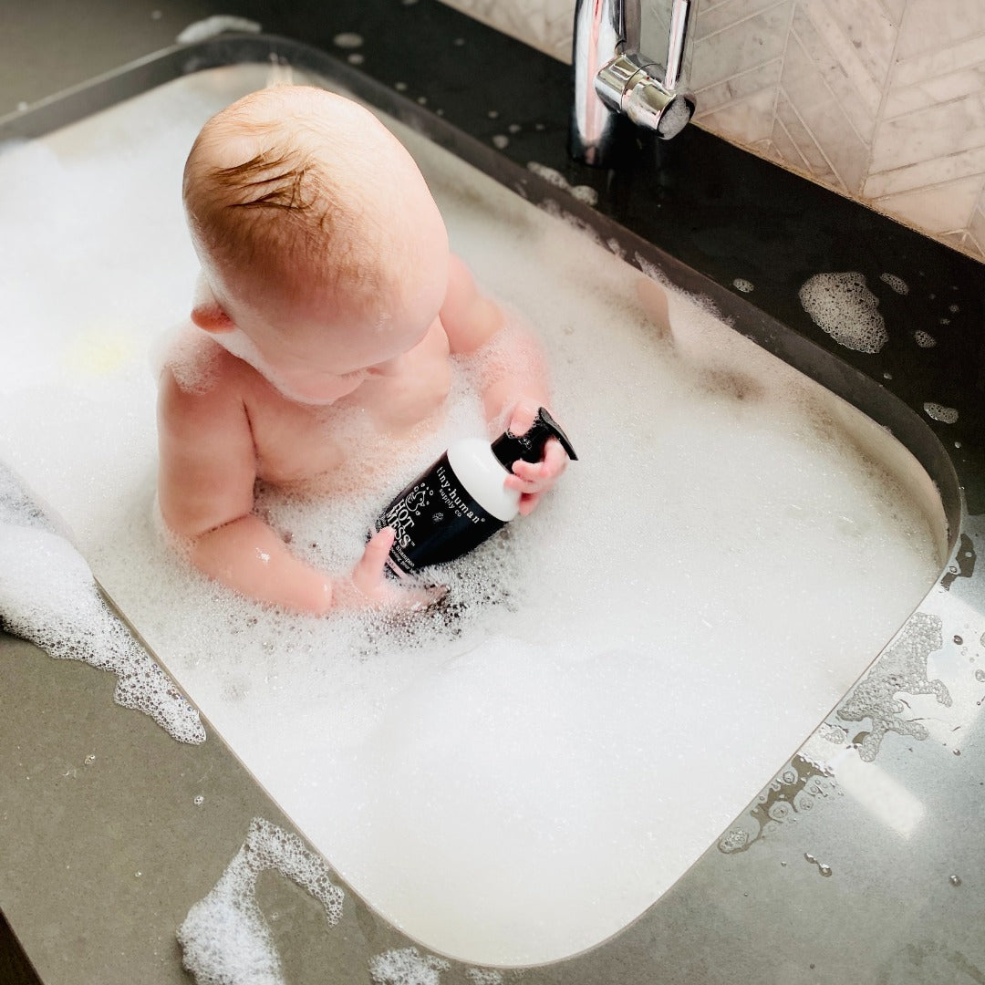baby in sink bubble bath with tiny human supply hot mess organic skincare