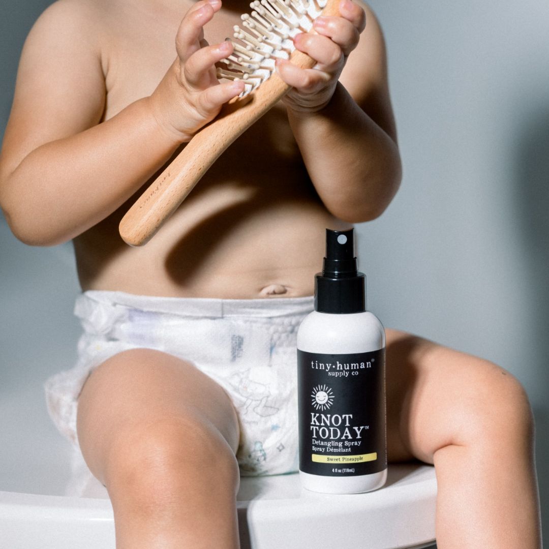 baby holding tiny human supply organic hair product knot today detangling spray